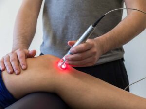 Laser therapy treatment being used on a knee